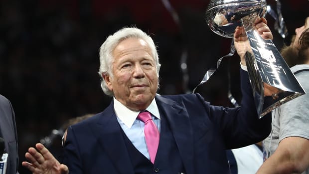 Robert Kraft holds the Vince Lombardi Trophy.